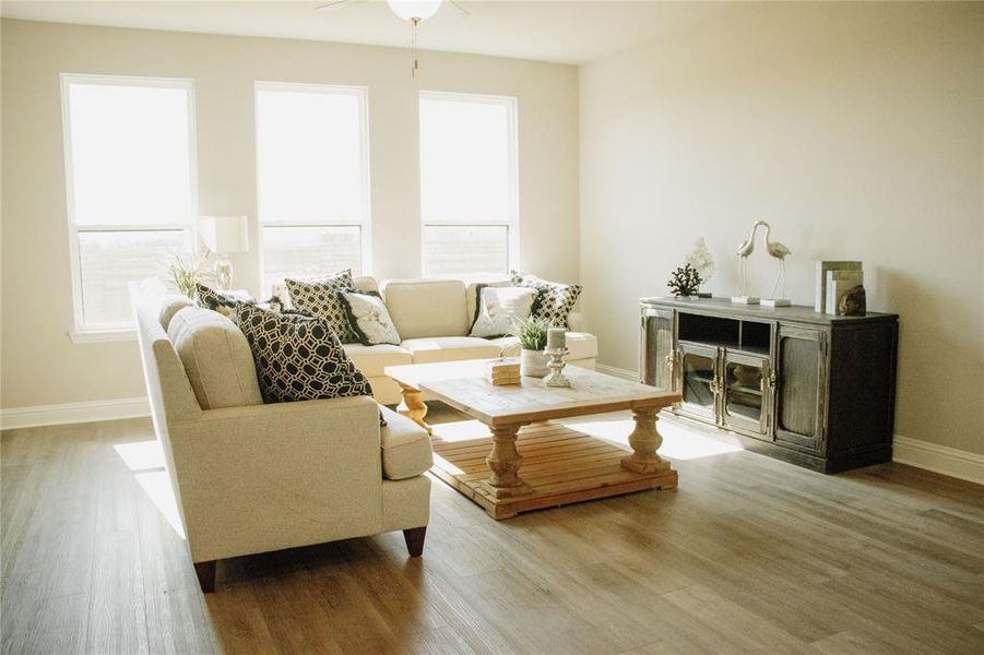 Living room featuring hardwood / wood-style flooring and ceiling fan