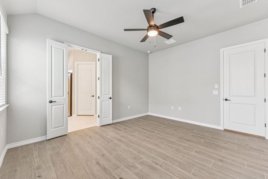 Unfurnished bedroom featuring light wood-style floors and ceiling fan Unfurnished bedroom featuring light wood-style floors and ceiling fan