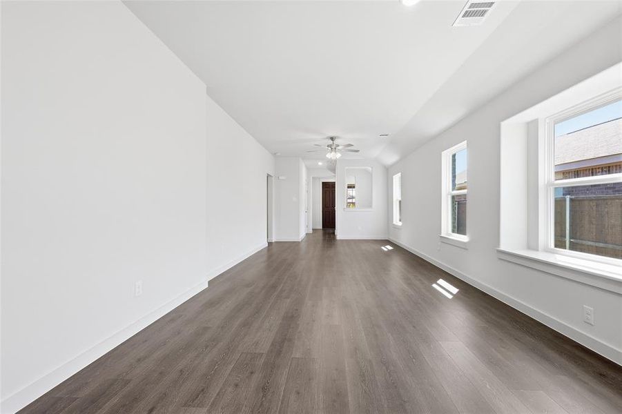 Unfurnished living room with dark wood-type flooring, recessed lighting, and ceiling fan