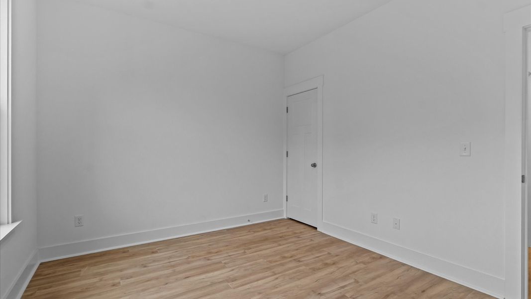 Functional secondary bedrooms with hardwood flooring and modern touches in an exceptional layout