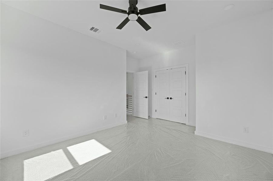 Spare room with light colored carpet and ceiling fan Spare room with light colored carpet and ceiling fan