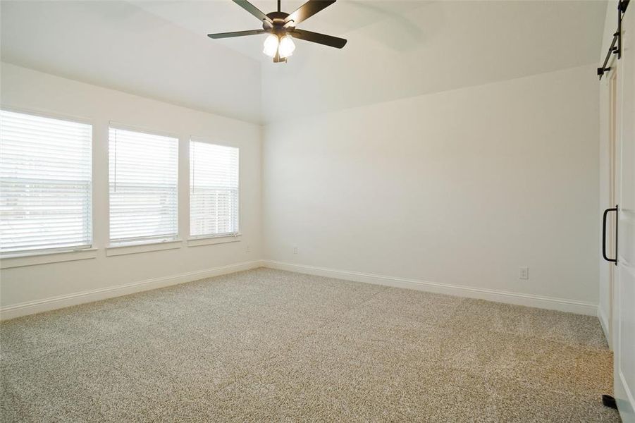 Spare room featuring carpet flooring and ceiling fan