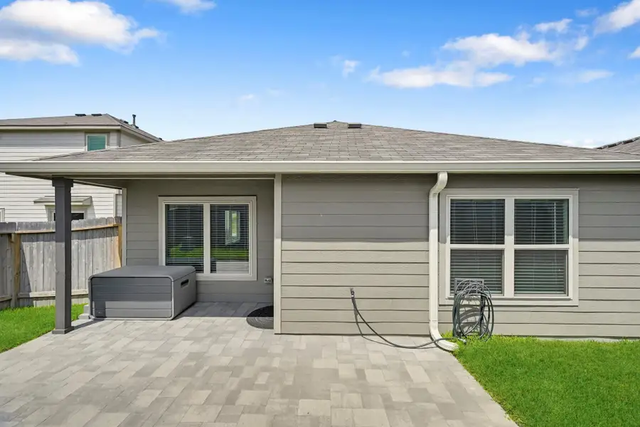 Step out back to the covered patio and enjoy a fenced backyard with a spacious extended paver patio.