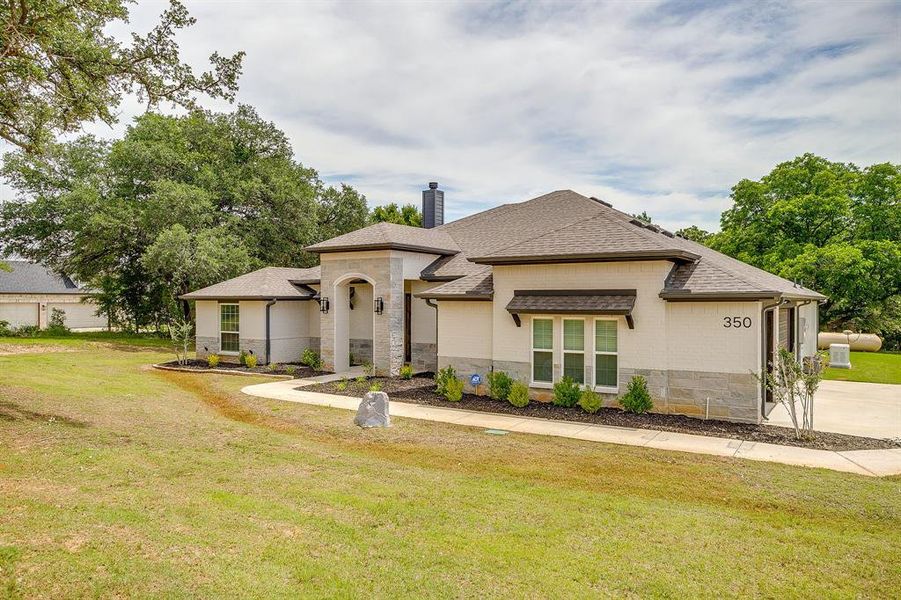 Front exterior of a new home in , Poolville, TX, highlighting curb appeal (Image 20). Front exterior of a new home in , Poolville, TX, highlighting curb appeal (Image 20).