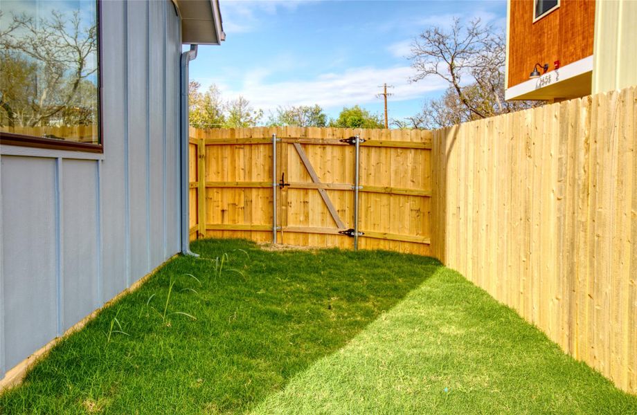 View of backyard with a gate