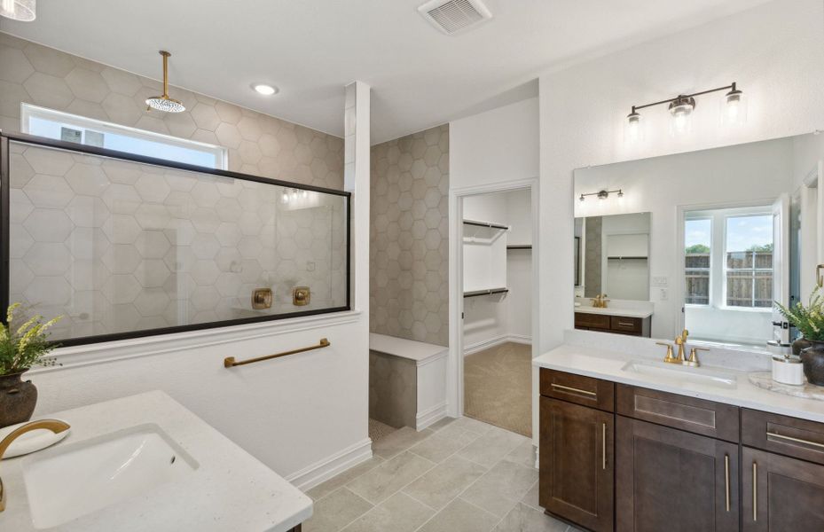 Owner's bath with separate vanities