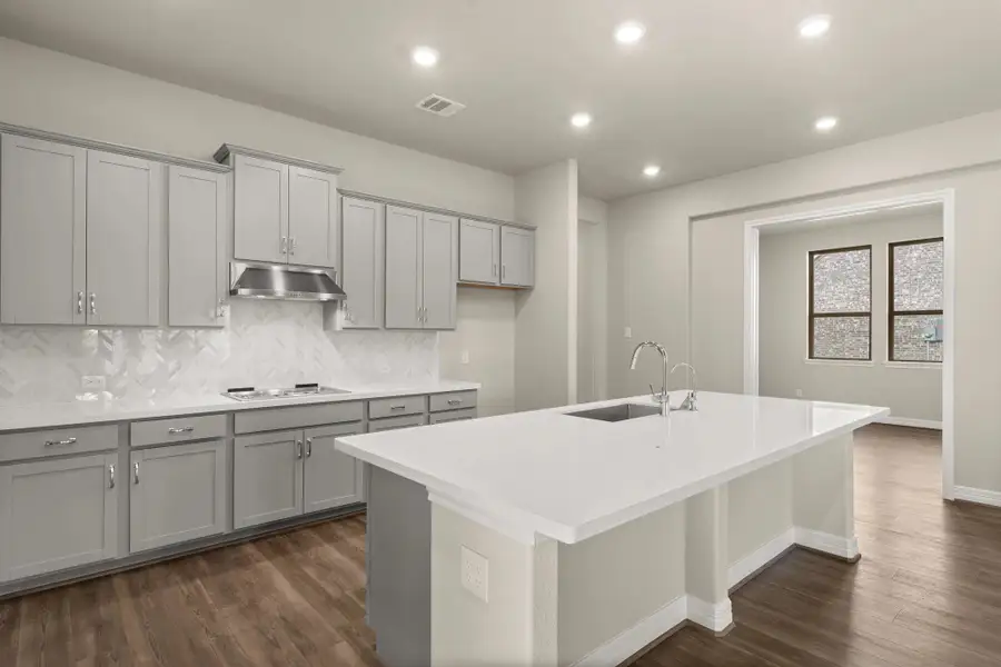 Kitchen open to dining room. Note: Sample product photo - actual exterior and interior selections may vary.