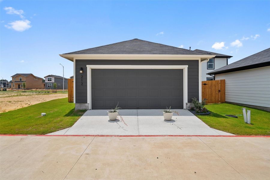 Front exterior of a new home in Valverde, Bastrop, TX, highlighting curb appeal (Image 25). Front exterior of a new home in Valverde, Bastrop, TX, highlighting curb appeal (Image 25).