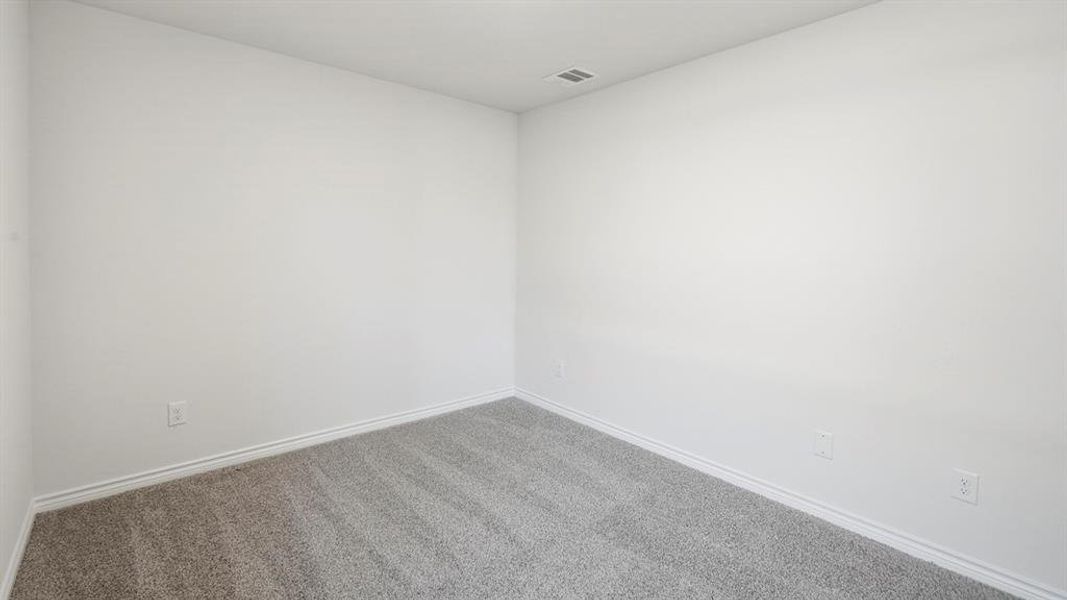 Carpeted empty room with baseboards Carpeted empty room with baseboards