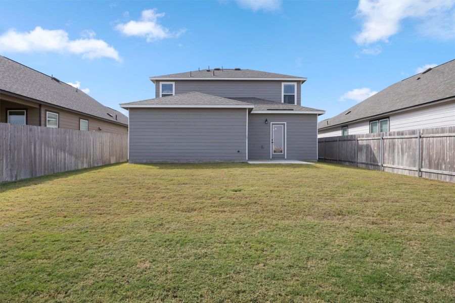 Back of property with a patio, a fenced backyard, and roof with shingles