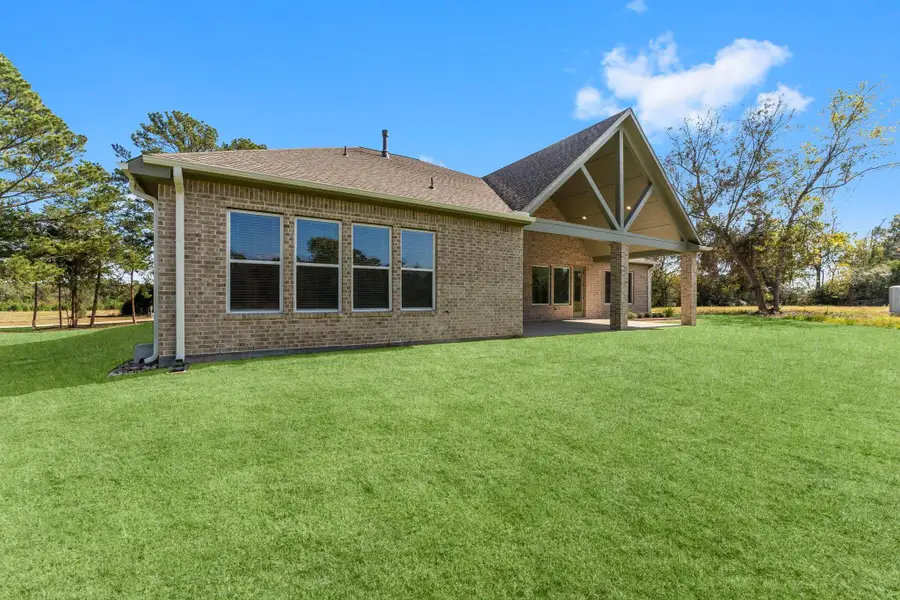 Exterior details and patio area of a home in Homestead Hill, New Waverly (Image 15).