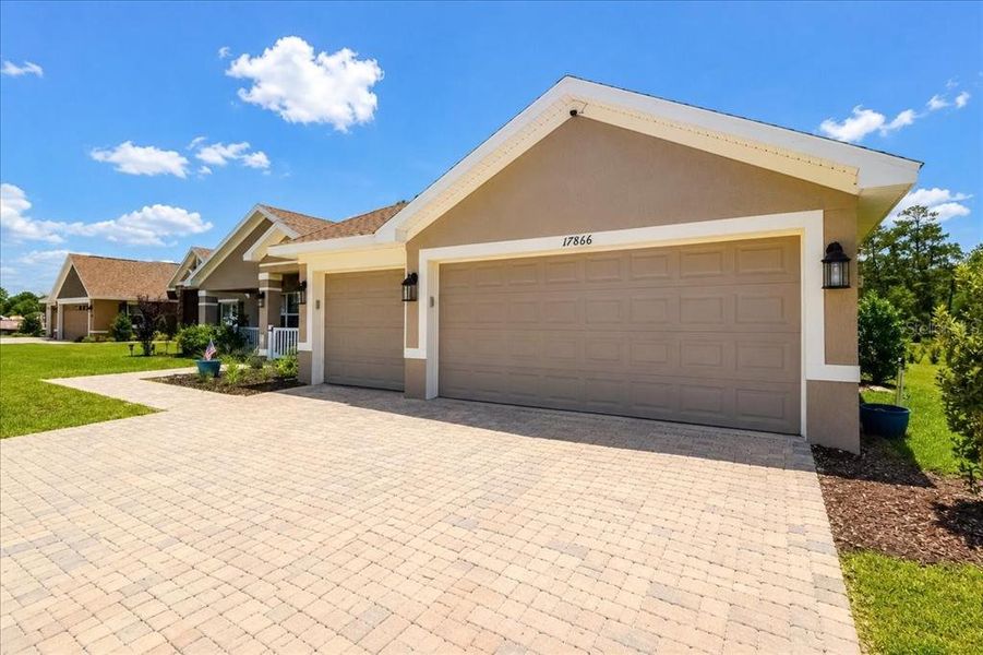 Front exterior of a new home in Juliette Falls, Dunnellon, FL, highlighting curb appeal (Image 23). Front exterior of a new home in Juliette Falls, Dunnellon, FL, highlighting curb appeal (Image 23).