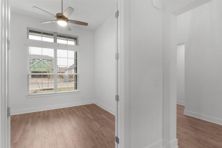 Unfurnished room with light wood-style floors and ceiling fan