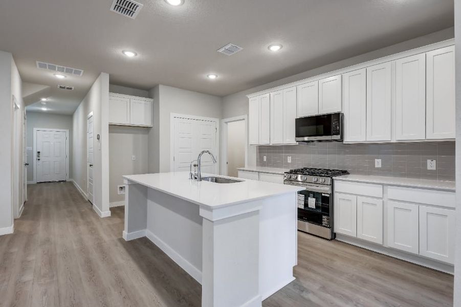 A kitchen with white cabinets. A kitchen with white cabinets.