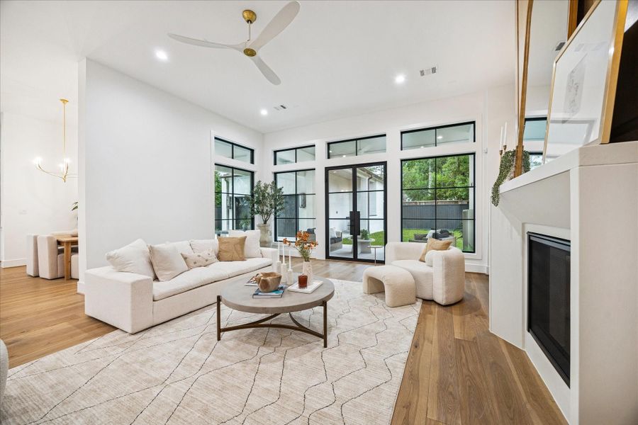 Thoughtfully placed openings, consistent flooring, and 8 ft doors create a seamless progression into the kitchen. Spray foam insulation and zoned Trane HVAC keep temperatures even across the main floor.