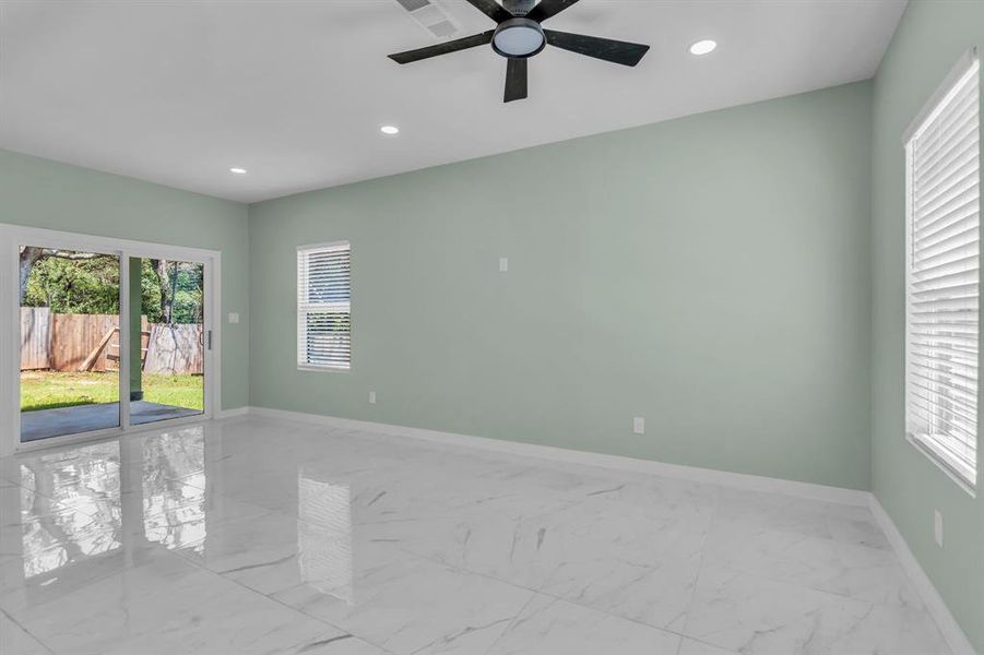 Unfurnished room featuring light marble finish flooring, recessed lighting, and ceiling fan Unfurnished room featuring light marble finish flooring, recessed lighting, and ceiling fan