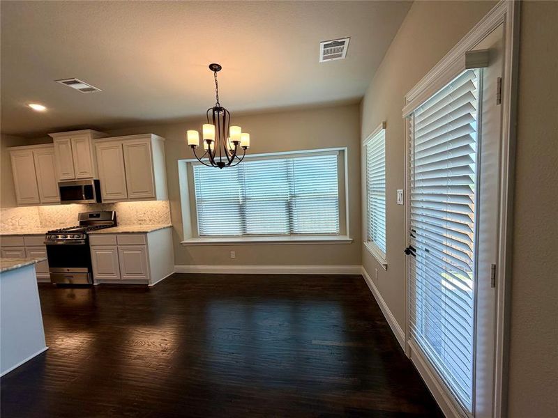 Cafe area off of kitchen with window seat & chandelier