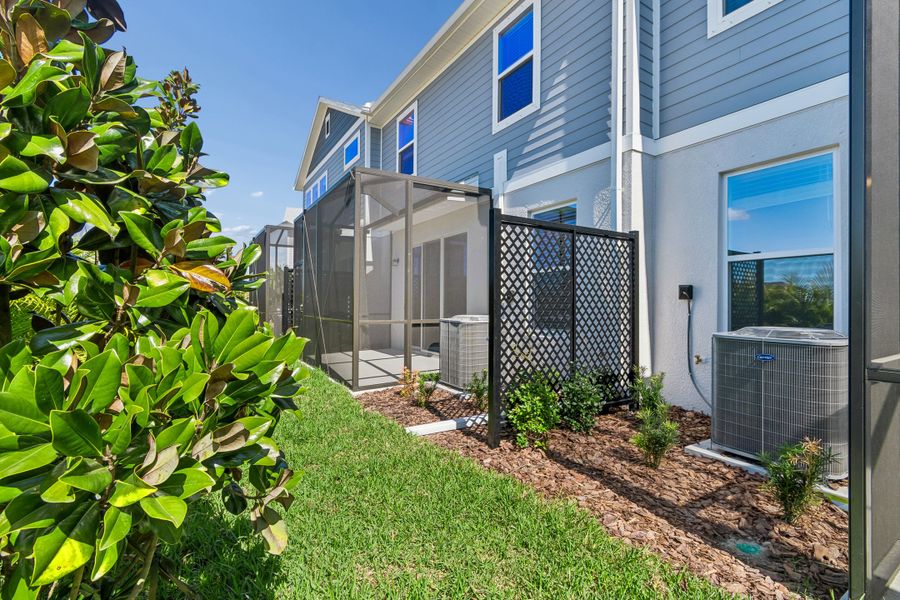 Exterior details and patio area of a home in North River Ranch – Townhomes, Parrish (Image 3).