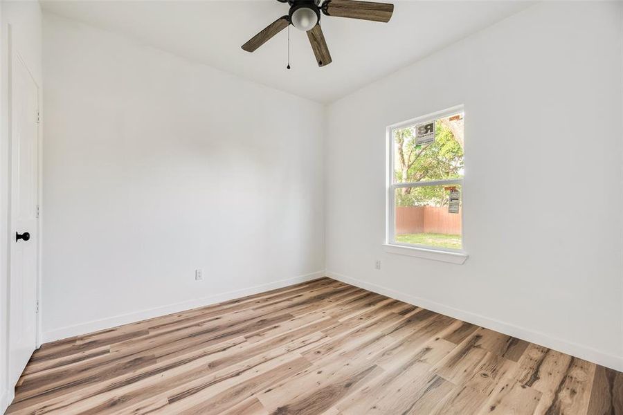 Spare room featuring light wood-style floors and ceiling fan