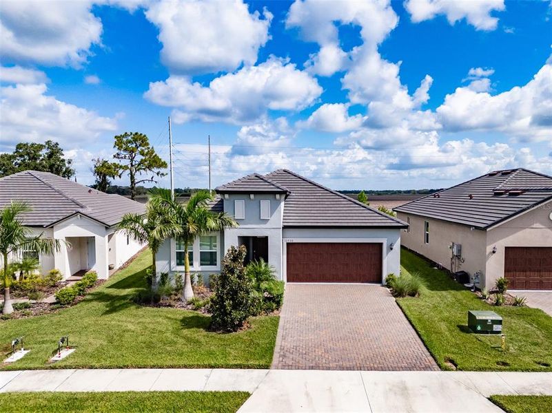 Front exterior of a new home in Prosperity Lakes, Parrish, FL, highlighting curb appeal (Image 26).