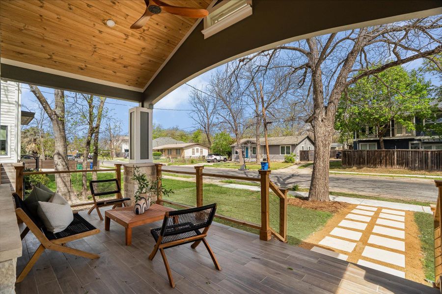 The property features a covered porch with a wood plank ceiling and a ceiling fan The property features a covered porch with a wood plank ceiling and a ceiling fan