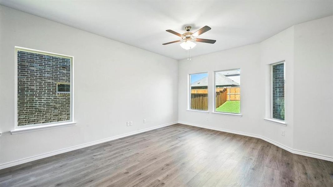 Spare room featuring wood finished floors and a ceiling fan