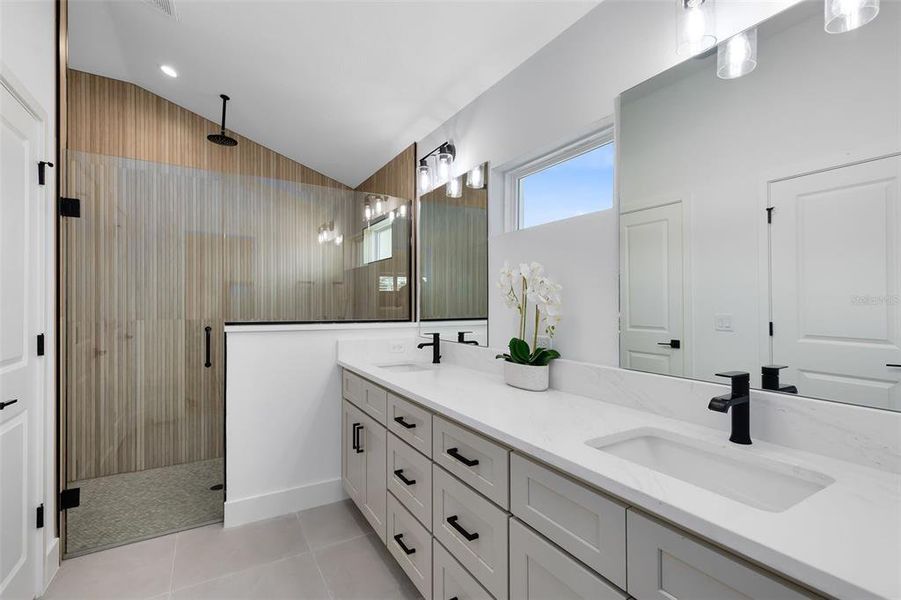 Your primary ensuite bath is equally impressive with a dual quartz vanity and a huge walk-in shower featuring a rainfall showerhead.