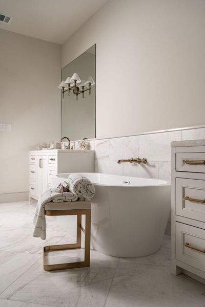 The 67" free-standing Mermaid soaking tub is the central point of the primary bathroom. The 67" free-standing Mermaid soaking tub is the central point of the primary bathroom.