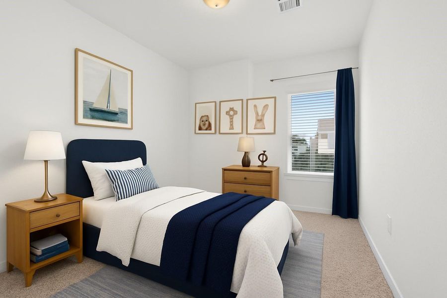 Cozy bedroom with a single bed featuring navy and white bedding. It includes a nightstand and dresser, both with lamps. Decorated with nautical artwork and a window with blue curtains, offering natural light. Perfect for a guest or child's room.