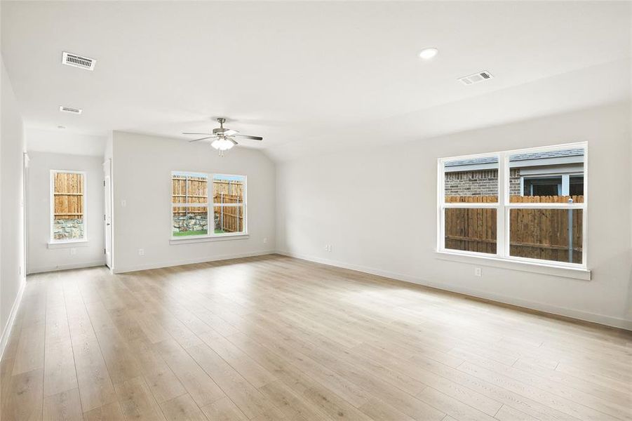 Empty room featuring a ceiling fan and light wood-style floors