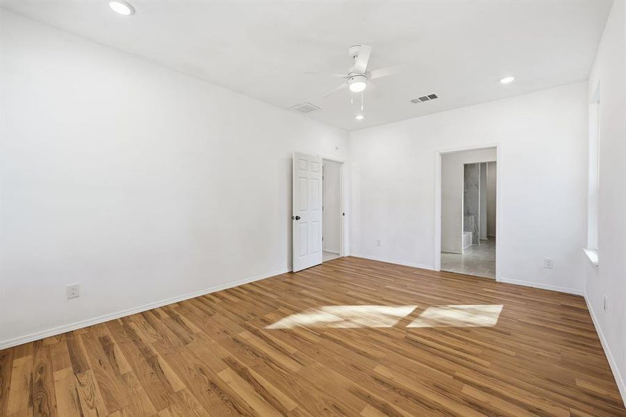 Primary bedroom featuring wood finished floors, recessed lighting, and ceiling fan