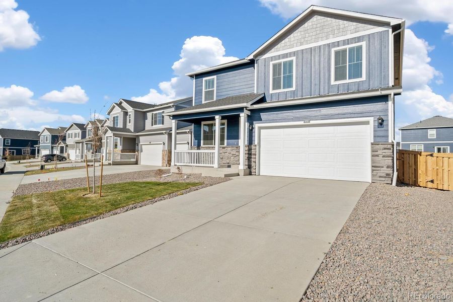 Front exterior of a new home in Trails at Crowfoot, Parker, CO, highlighting curb appeal (Image 1). Front exterior of a new home in Trails at Crowfoot, Parker, CO, highlighting curb appeal (Image 1).