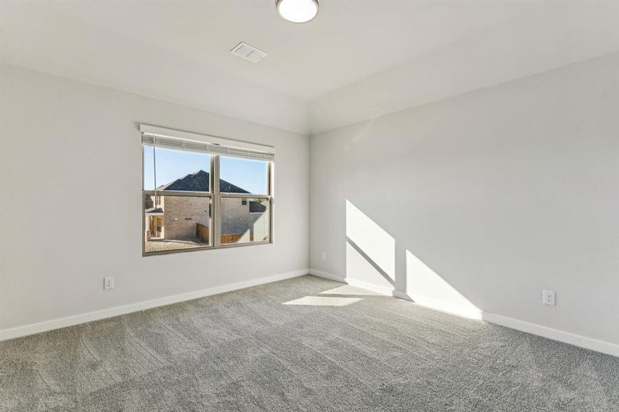 Bedroom in the Wimbledon home plan by Trophy Signature Homes – REPRESENTATIVE PHOTO