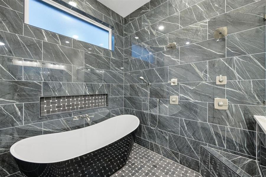 Full bath featuring tile walls and a freestanding bath Full bath featuring tile walls and a freestanding bath