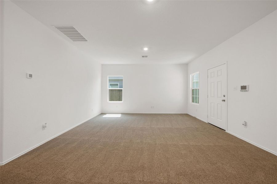 Empty room with light colored carpet and baseboards Empty room with light colored carpet and baseboards