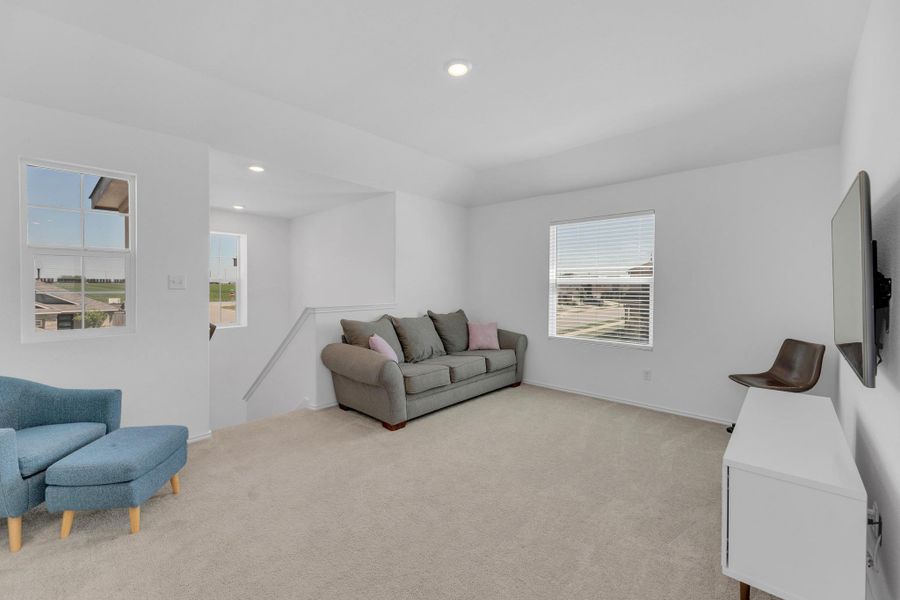 Living room featuring light colored carpet and recessed lighting