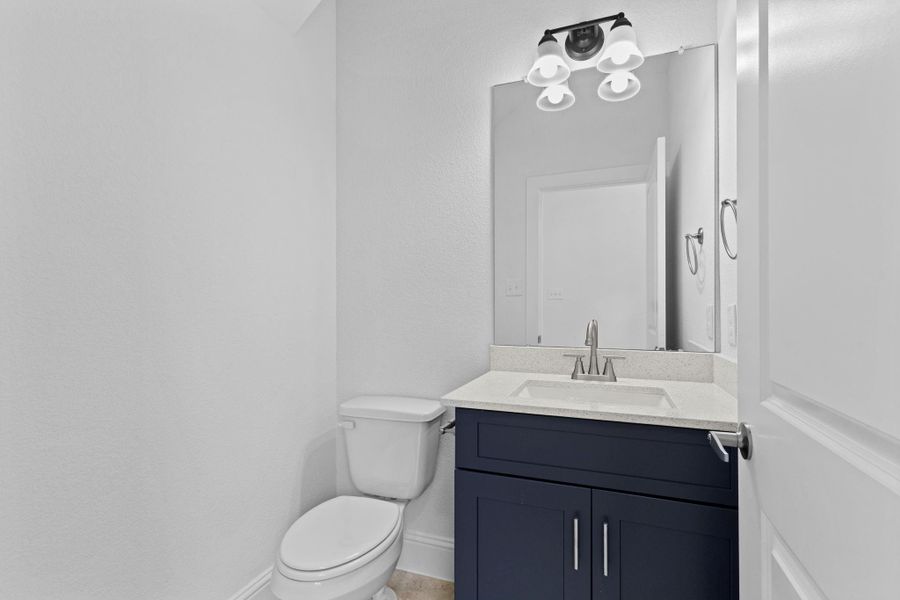 Guest half bathroom has beautiful quartz countertop with deep undermount sink.
