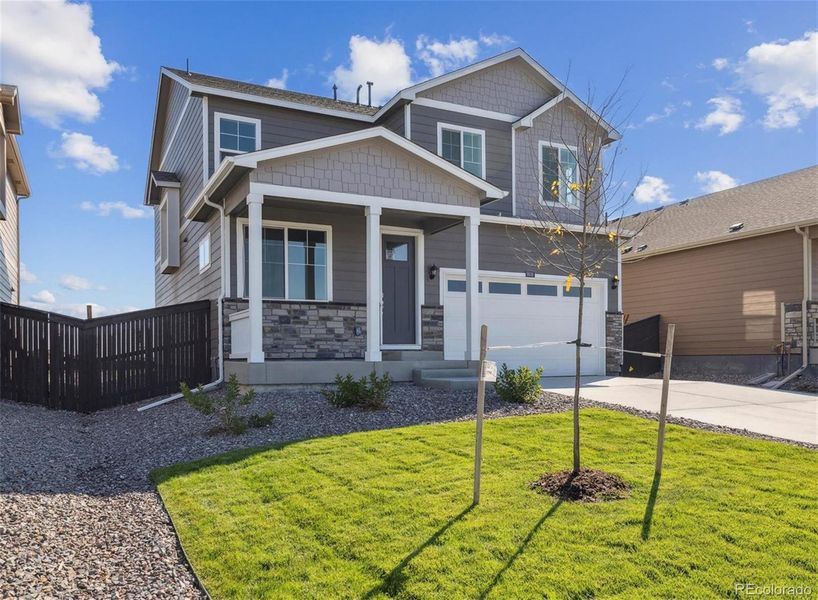 Front exterior of a new home in Settlers Crossing, Commerce City, CO, highlighting curb appeal (Image 2).