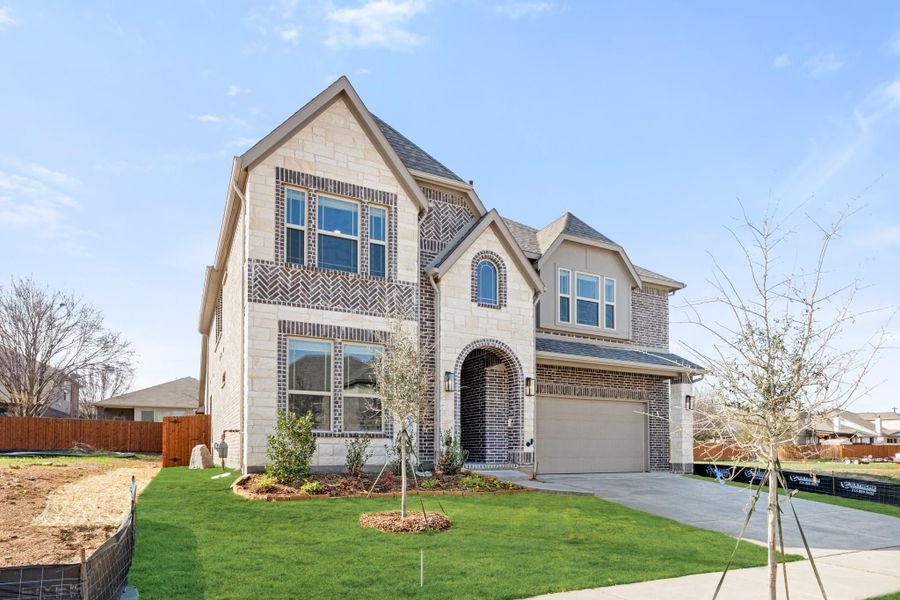 Two-story new construction home with stone and brick exterior, arched entry, two-car garage, and landscaped front yard. Two-story new construction home with stone and brick exterior, arched entry, two-car garage, and landscaped front yard.