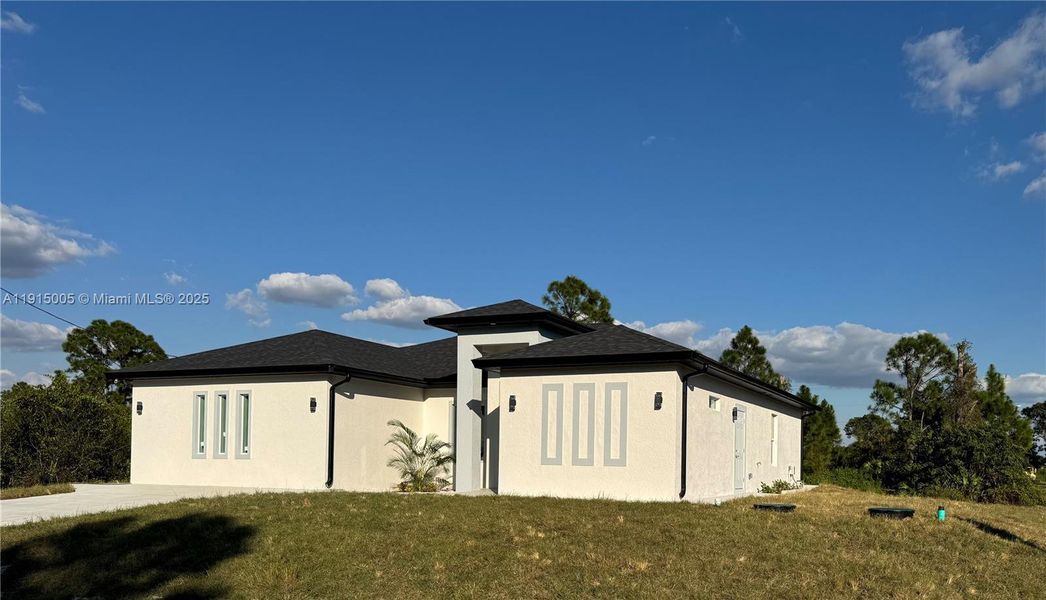 Front exterior of a new home in , Lehigh Acres, FL, highlighting curb appeal (Image 17).