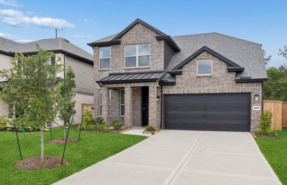 Front exterior of a new home in Mavera, Conroe, TX, highlighting curb appeal (Image 2). Front exterior of a new home in Mavera, Conroe, TX, highlighting curb appeal (Image 2).