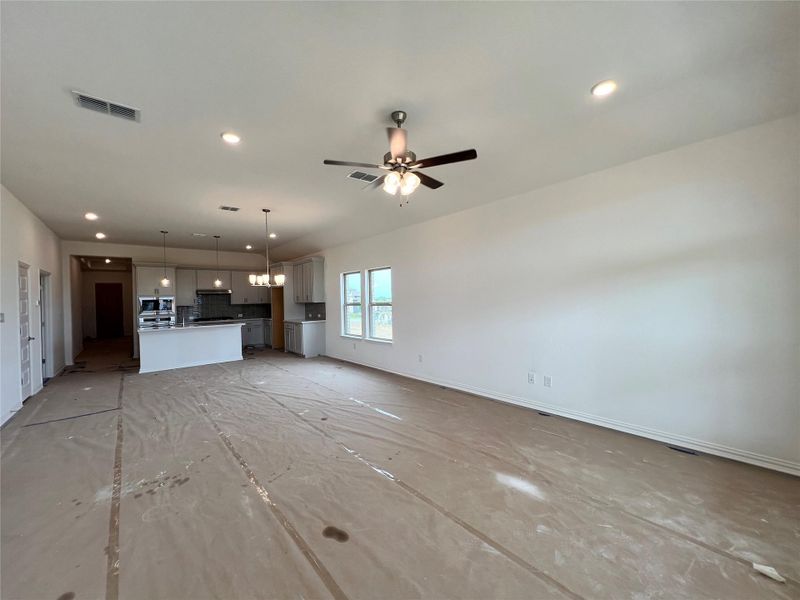 Unfurnished living room with a ceiling fan and recessed lighting Unfurnished living room with a ceiling fan and recessed lighting