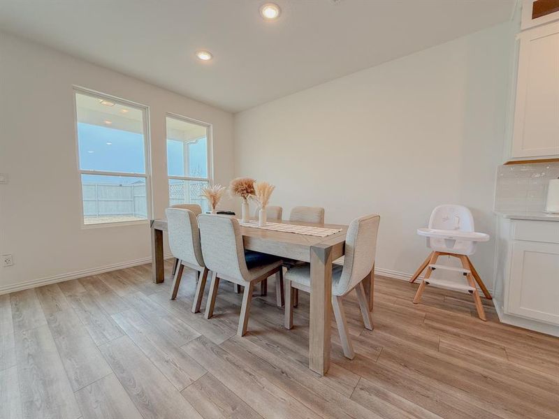 Dining space featuring light wood-style flooring, baseboards, and recessed lighting