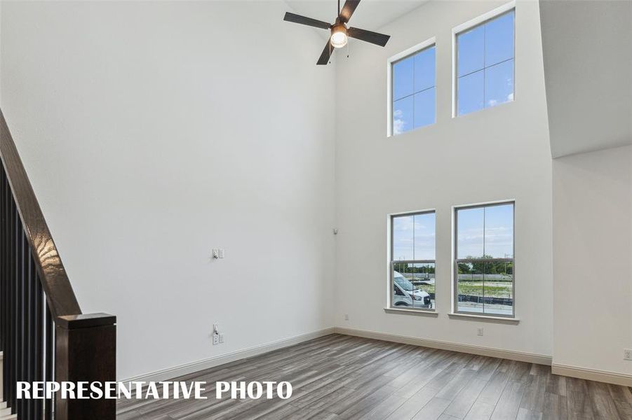 Featuring volume windows in the family room, this beautiful home is filled with natural light.  REPRESENTATIVE PHOTO