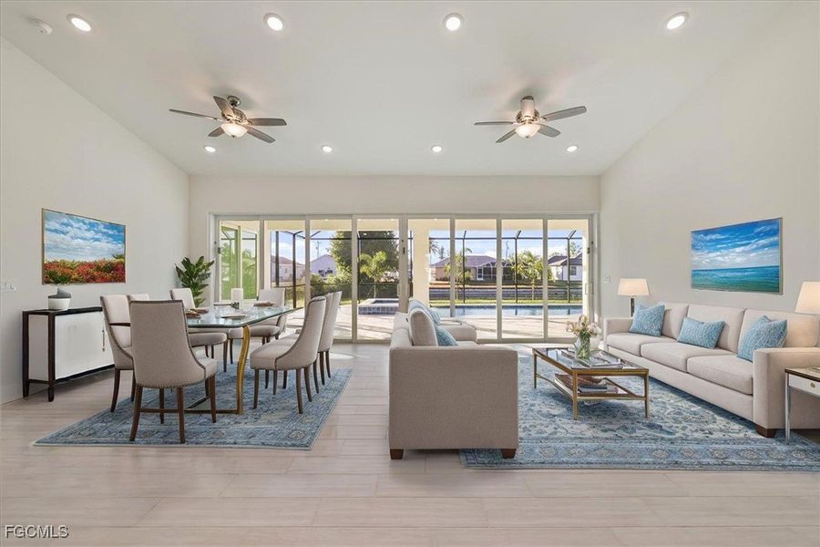 Living area featuring healthy amount of natural light, ceiling fan, and recessed lighting Living area featuring healthy amount of natural light, ceiling fan, and recessed lighting
