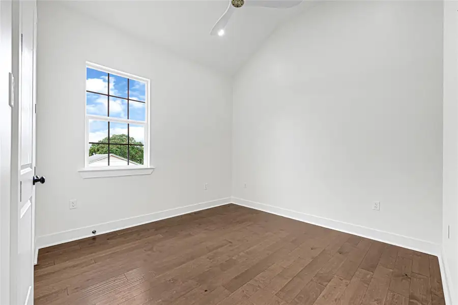 Spacious third bedroom featuring built-in cabinets and shelves for stylish storage solutions.