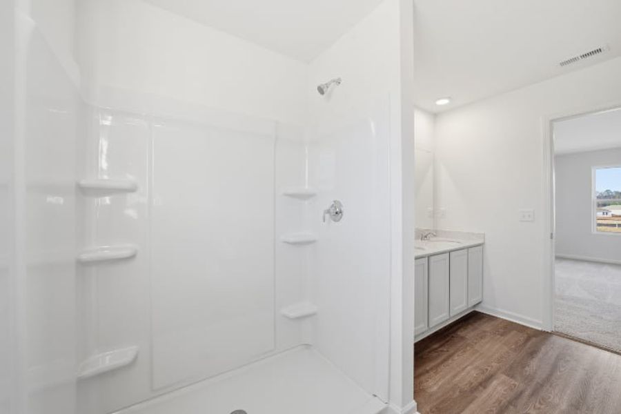 A bathroom with a glass shower. A bathroom with a glass shower.