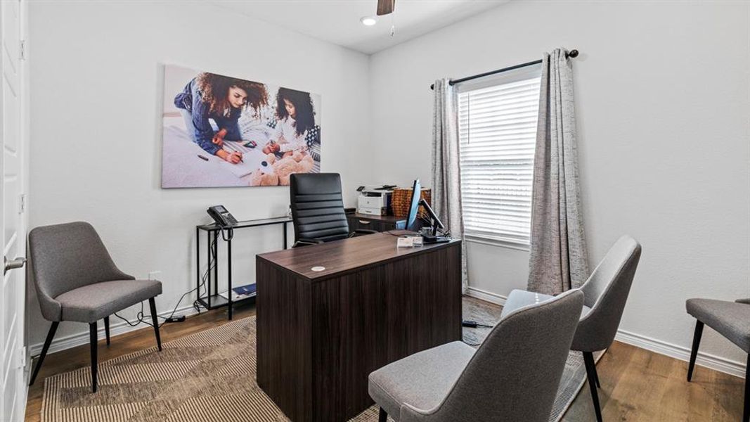 Versatile room featuring wood-finish flooring, a ceiling fan, and a window with blinds Versatile room featuring wood-finish flooring, a ceiling fan, and a window with blinds