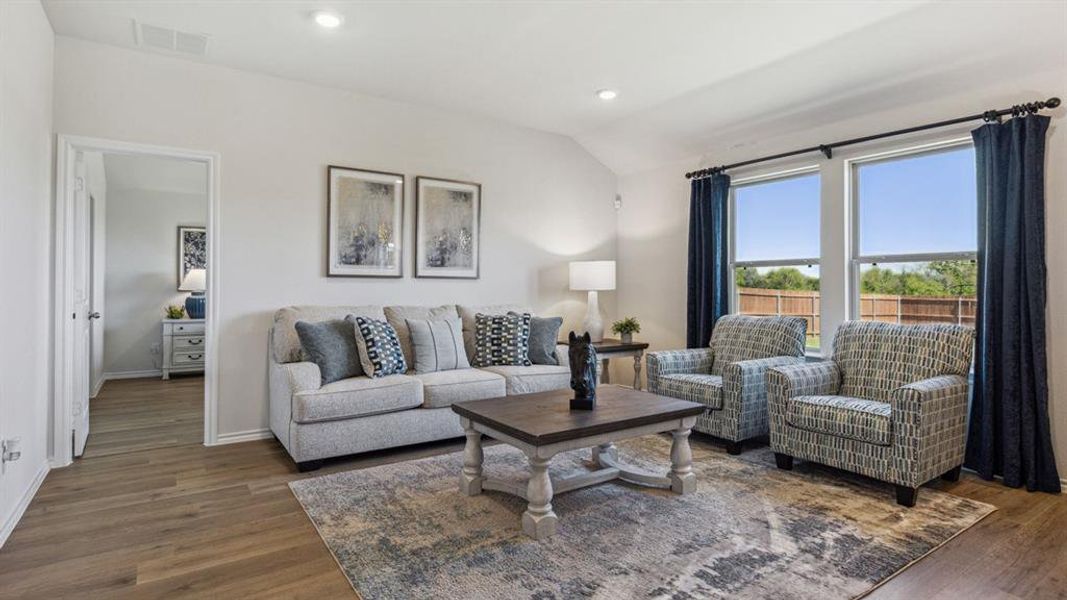 Living room featuring recessed lighting, dark wood finished floors, and lofted ceiling