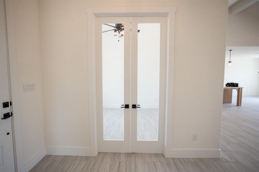 Doorway to outside with french doors and wood finished floors Doorway to outside with french doors and wood finished floors